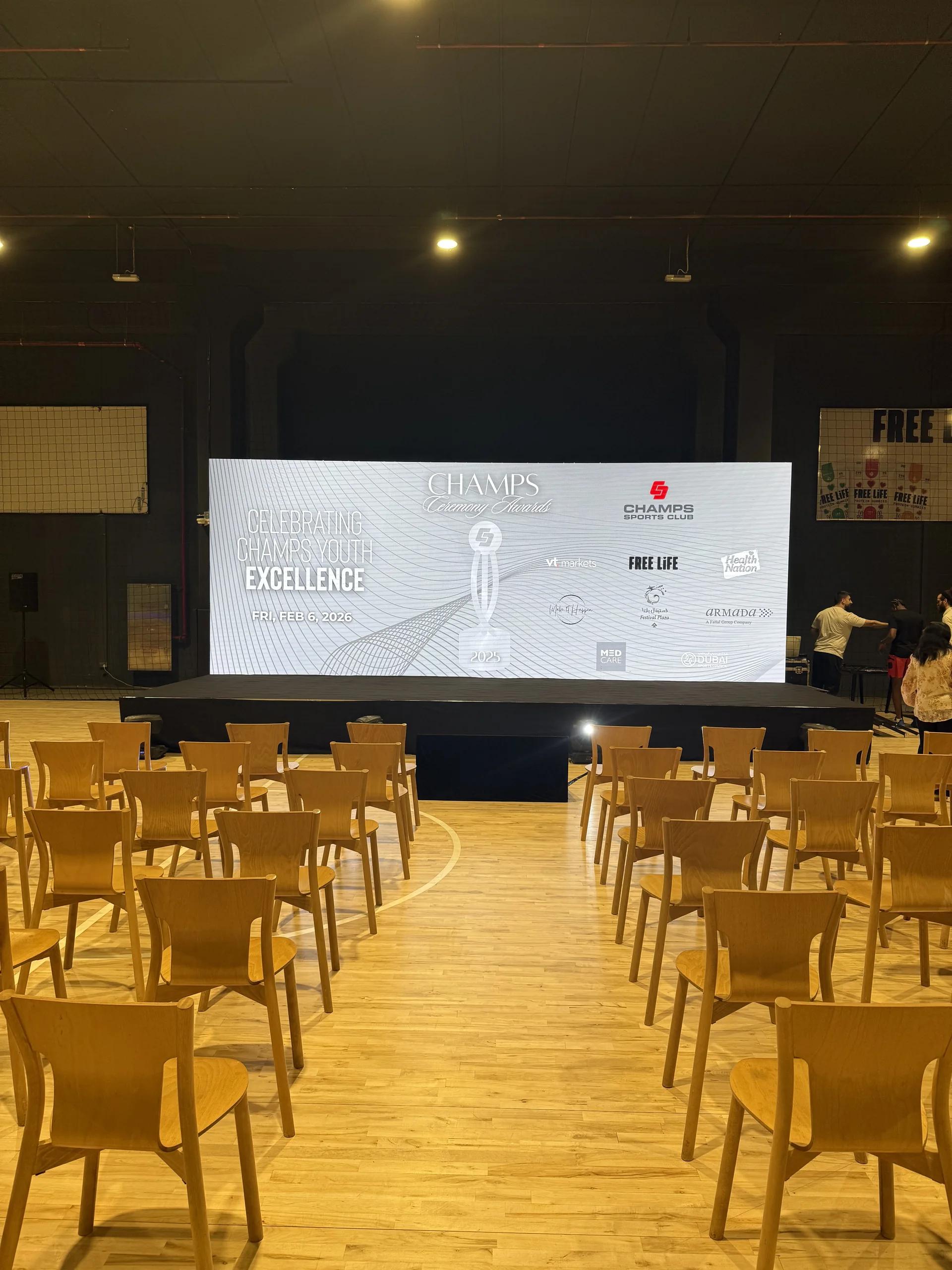 Large indoor screen environment prepared with floor seating.