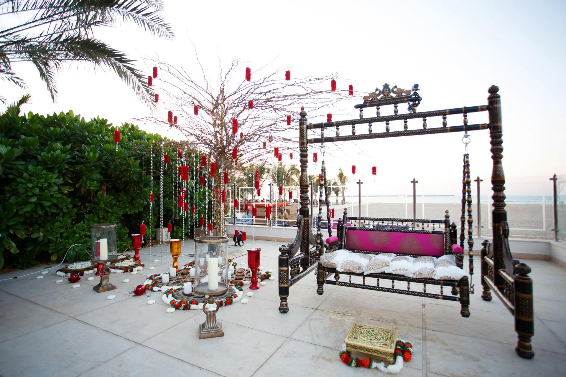 Outdoor ceremony structure and guest seating prepared beside a pool.