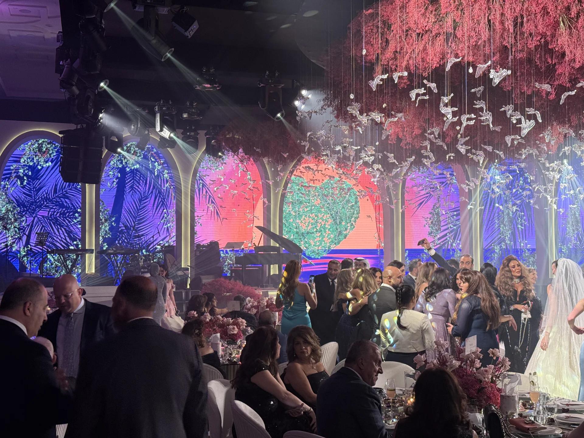 Private celebration with a live stage, suspended scenic details and guests.